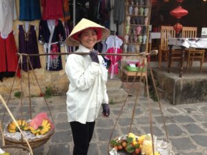 Selling fruit in a conical hat