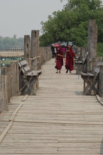 Monks walking on a bridge - InsideBurma Tours