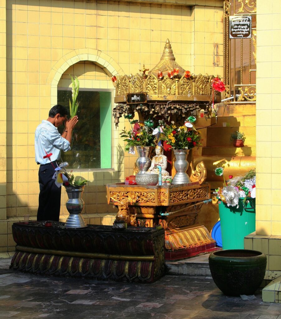 Man praying in Sule Pagoda Yangon, Burma (Myanmar)