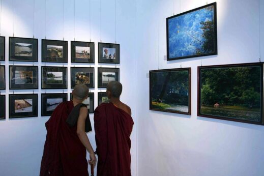Monks admiring art at Gallery 65 in Yangon