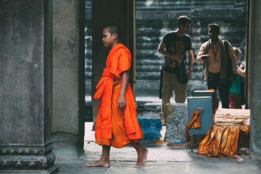 Young monk walking through Angkor Wat Siem Reap