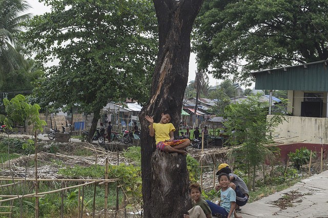 Children waving outside of Yangon's circle train, Burma (Myanmar)
