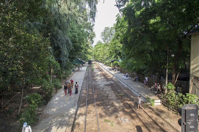 People strolling by the tracks next to Yangon's circle train, Burma (Myanmar)