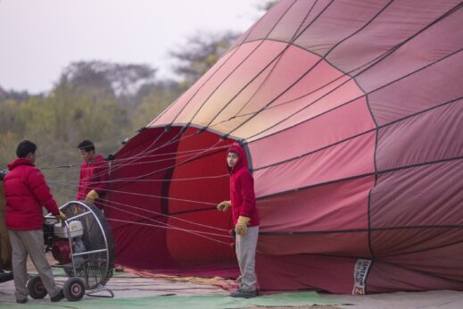 Local people helping with the landing of a Hot air balloon in Bagan